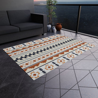 Mexican Boho outdoor rug on a grey tiled terrace next to an outdoor sofa