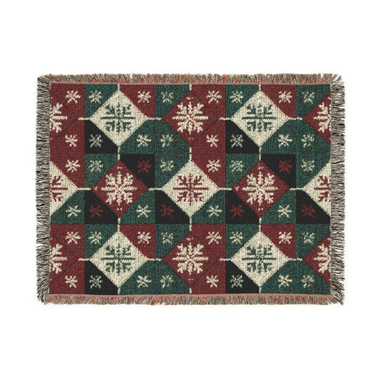 Nordic Knit woven blanket with red and cream snowflake diamonds on forest green in a knit look, shown flat