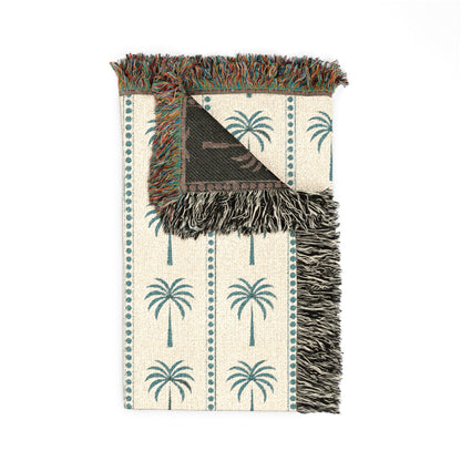 Folded Palm Tree woven blanket showing the fringed edge and the charcoal reverse side
