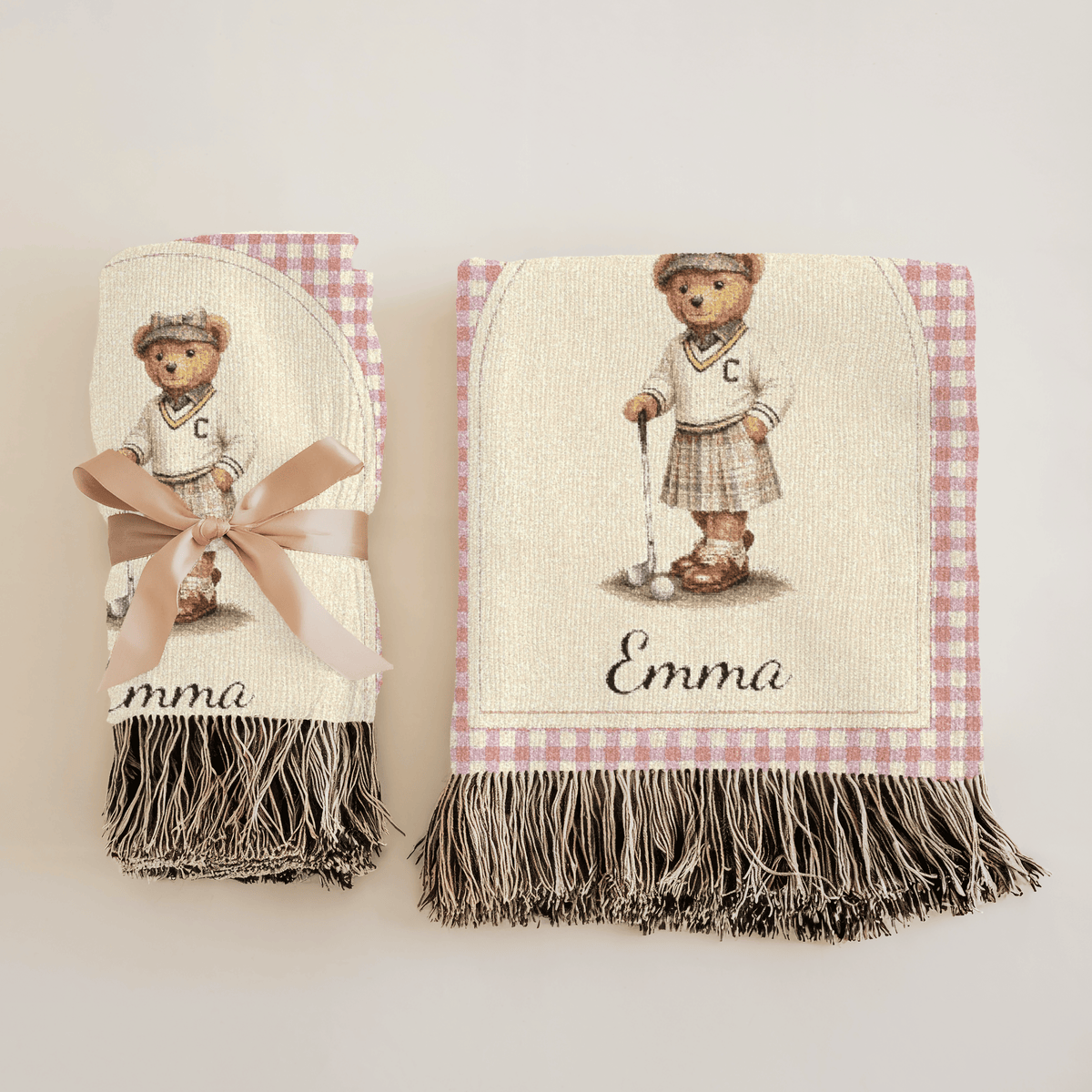 Personalized bear golf baby blanket folded on a crib with a teddy bear