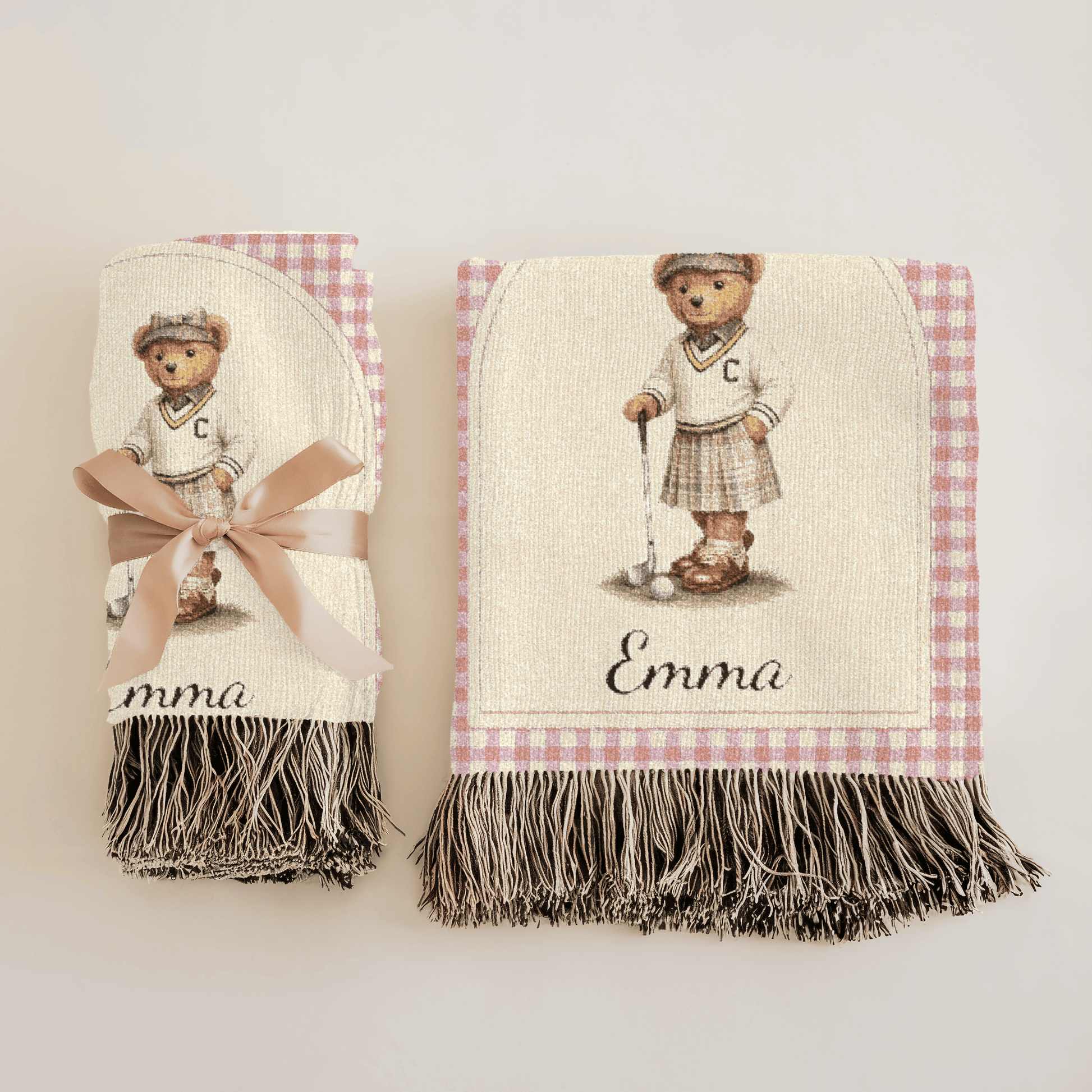Personalized bear golf baby blanket folded on a crib with a teddy bear