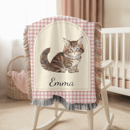 Personalized cat baby blanket hanging over the side of a wooden crib