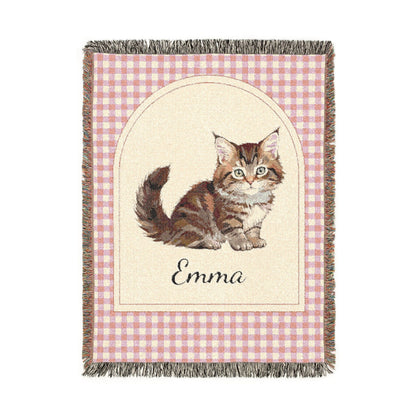 Personalized woven baby blanket with a tabby cat and a name on a pink gingham border, shown flat