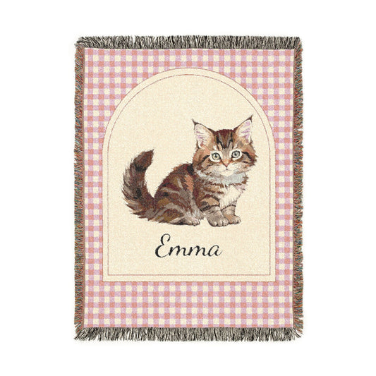 Personalized woven baby blanket with a tabby cat and a name on a pink gingham border, shown flat