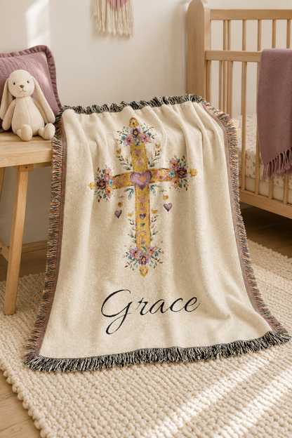 Personalized baptism blanket over the rail of a wooden crib in a nursery