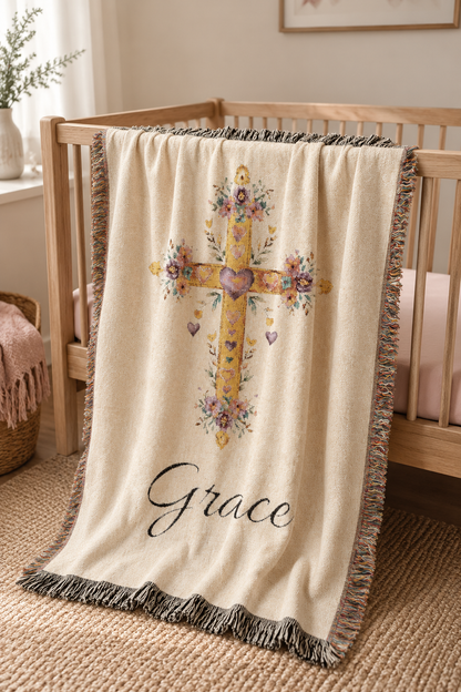 Personalized baptism blanket over a crib in a bright neutral nursery