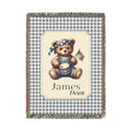 Personalized patriotic teddy bear blanket with a bear in dungarees holding a flag and drum on blue gingham, with a first and middle name woven in, shown flat