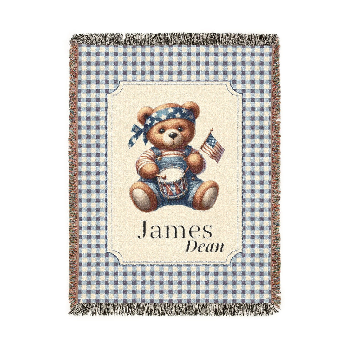 Personalized patriotic teddy bear blanket with a bear in dungarees holding a flag and drum on blue gingham, with a first and middle name woven in, shown flat