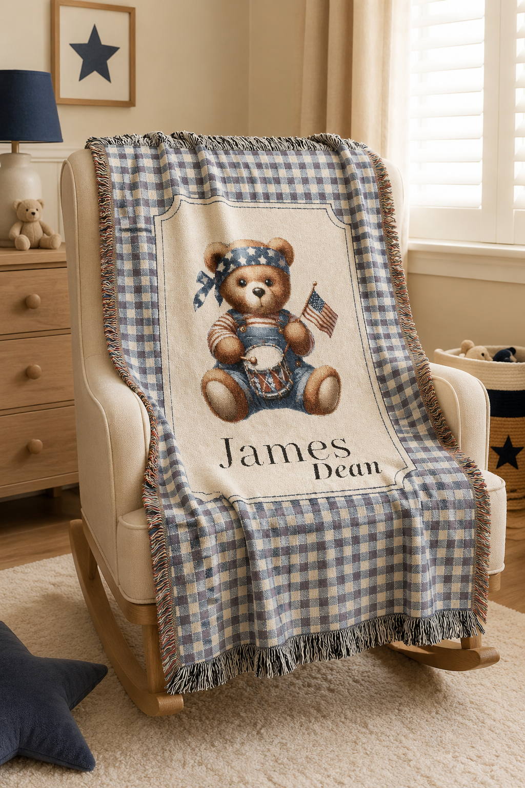 Personalized patriotic teddy bear blanket over a rocking chair in a bright nursery