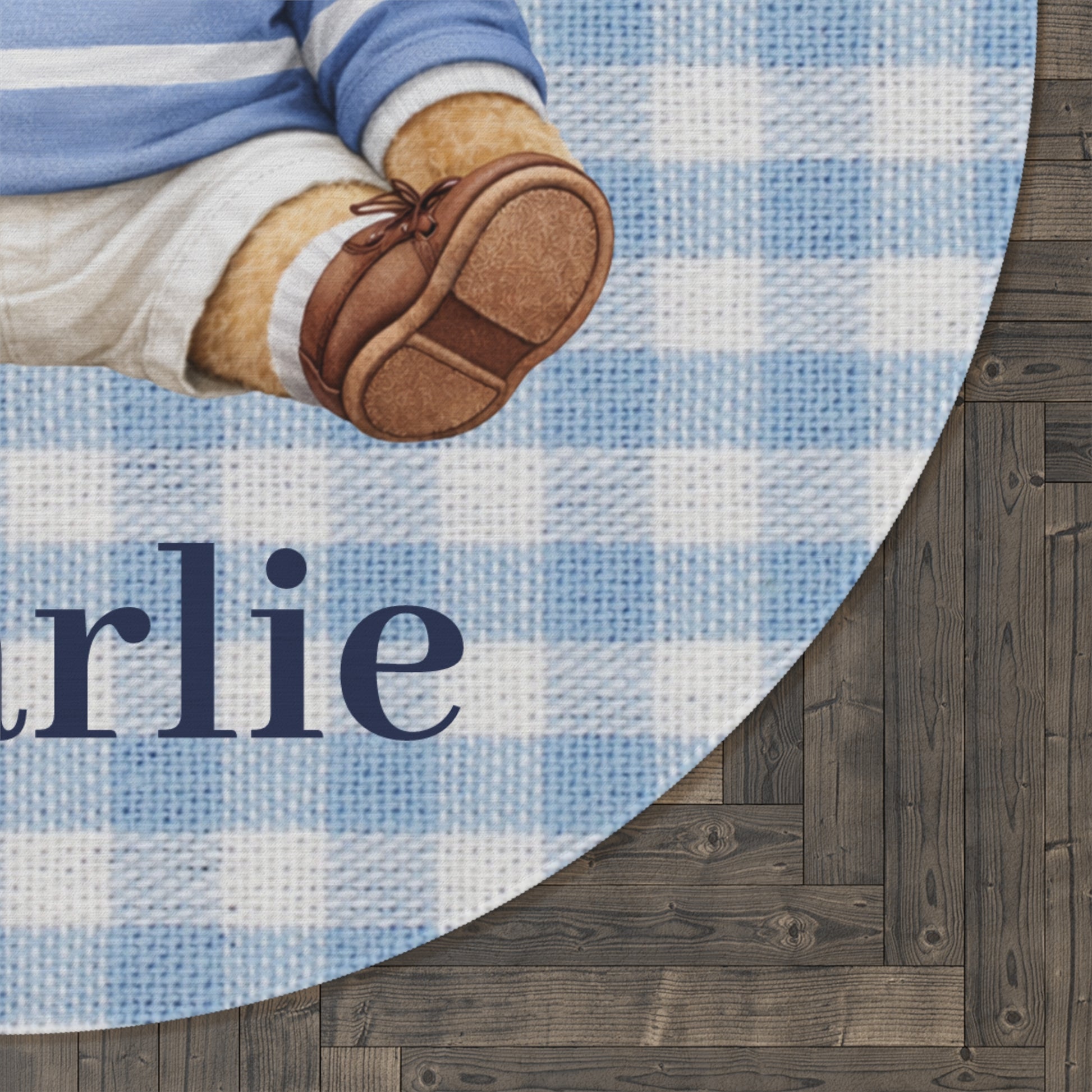 Close-up of the personalized teddy bear round rug showing the woven name on a dark wood floor
