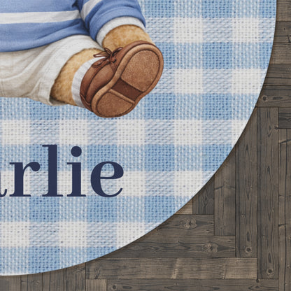 Close-up of the personalized teddy bear round rug showing the woven name on a dark wood floor