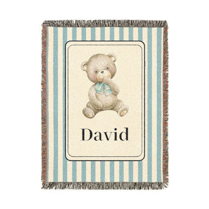 Personalized woven baby blanket with a watercolour teddy bear in a cream panel on a blue and cream stripe, with a name woven in, shown flat