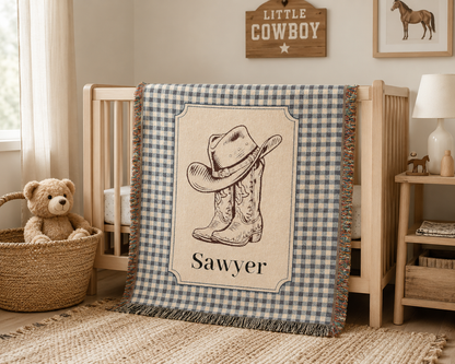 Personalized cowboy baby blanket in a nursery with a woven basket and soft toys