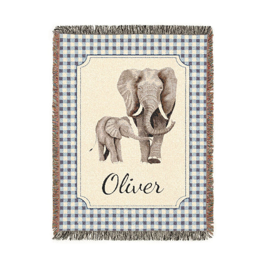 Personalized woven baby blanket with an elephant and calf on a cream panel with a blue gingham border and a name woven in, shown flat