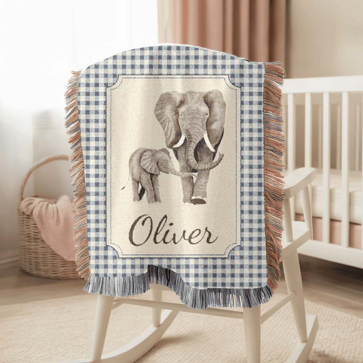 Personalized elephant baby blanket over a rocking chair beside a crib