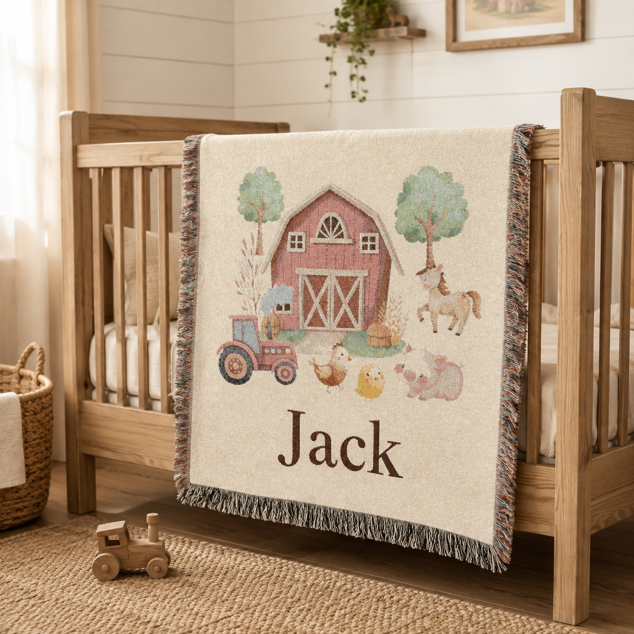 Personalized farm baby blanket draped over the rail of a wooden crib
