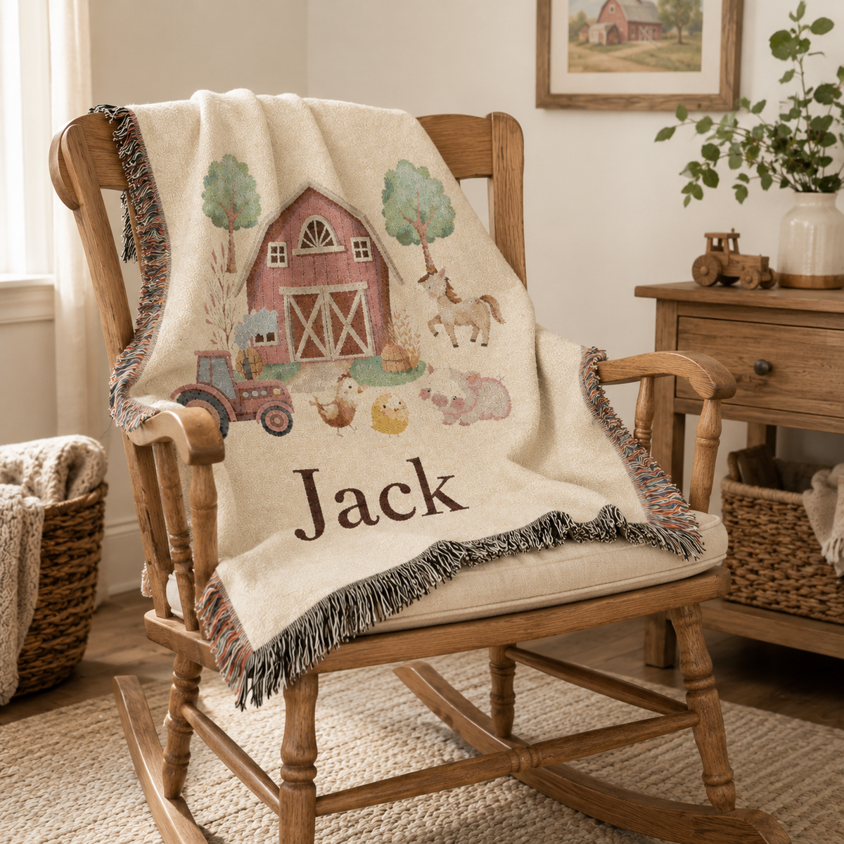 Personalized farm baby blanket over a wooden rocking chair in a nursery with framed art