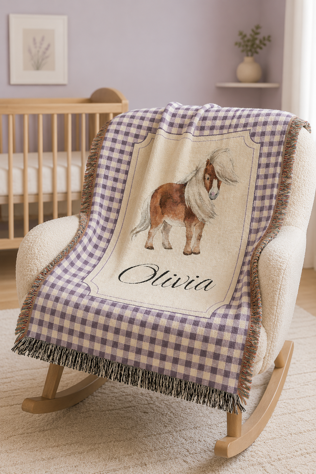 Personalized pony baby blanket over a wooden crib in a neutral nursery