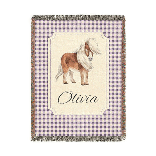 Personalized woven baby blanket with a chestnut pony in a framed panel on mauve gingham, with a name woven in, shown flat