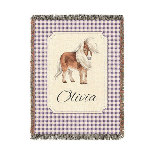 Personalized woven baby blanket with a chestnut pony in a framed panel on mauve gingham, with a name woven in, shown flat