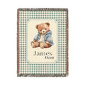Personalized woven baby blanket with a teddy bear in a blue jacket on sage gingham, with a first and middle name woven in, shown flat