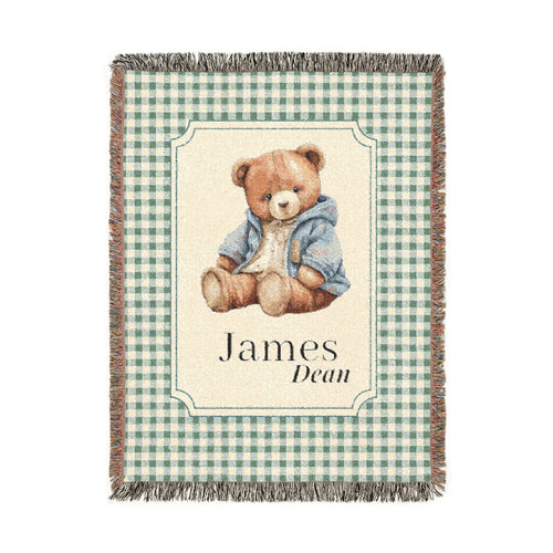 Personalized woven baby blanket with a teddy bear in a blue jacket on sage gingham, with a first and middle name woven in, shown flat