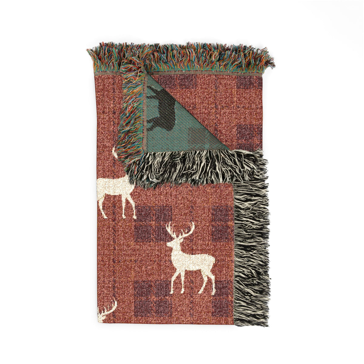 Reindeer plaid woven blanket styled on a bed in a cozy bedroom