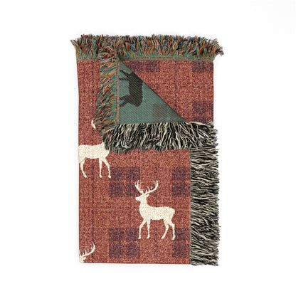 Reindeer plaid woven blanket styled on a bed in a cozy bedroom