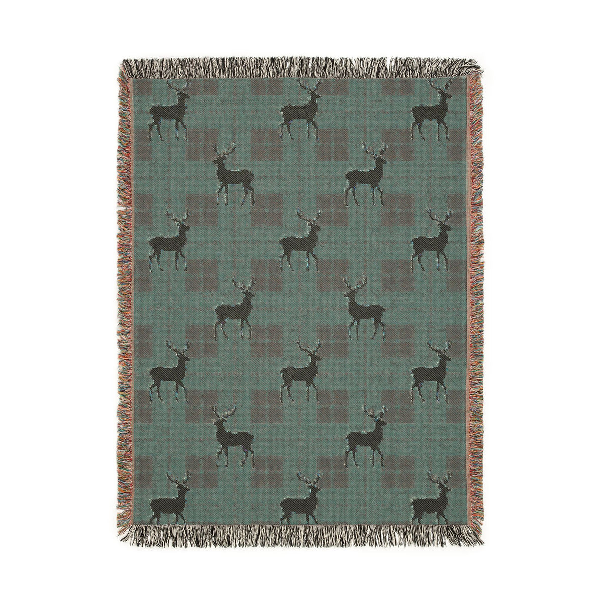 Folded corner detail of the reindeer plaid woven blanket showing the fringe edge