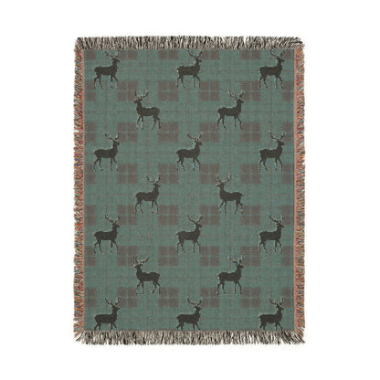 Folded corner detail of the reindeer plaid woven blanket showing the fringe edge