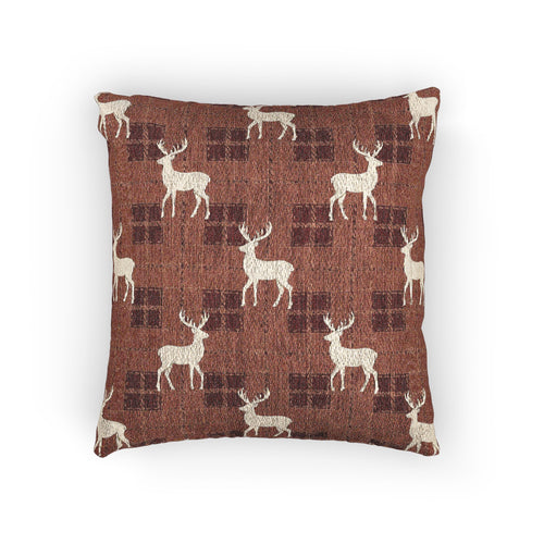 Reindeer plaid woven pillow featuring cream reindeer silhouettes on a rust buffalo-check pattern