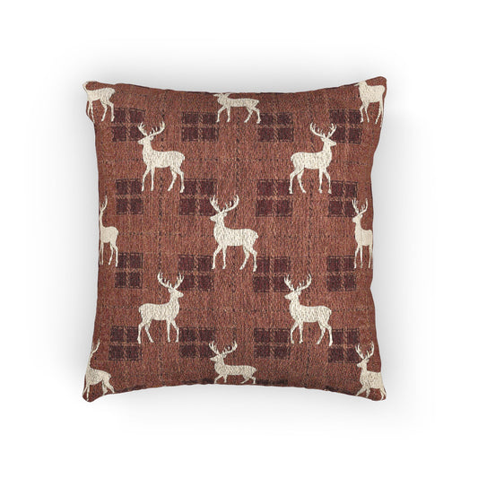 Reindeer plaid woven pillow featuring cream reindeer silhouettes on a rust buffalo-check pattern