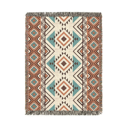 Rust and teal Aztec diamond woven blanket with concentric diamonds in navy, rust and cream, shown flat