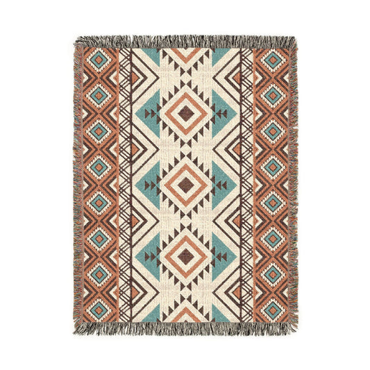 Rust and teal Aztec diamond woven blanket with concentric diamonds in navy, rust and cream, shown flat