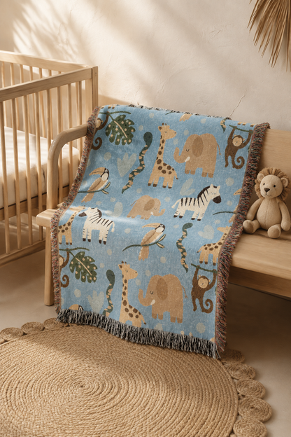 Safari animals woven baby blanket over the rail of a wooden crib in a nursery