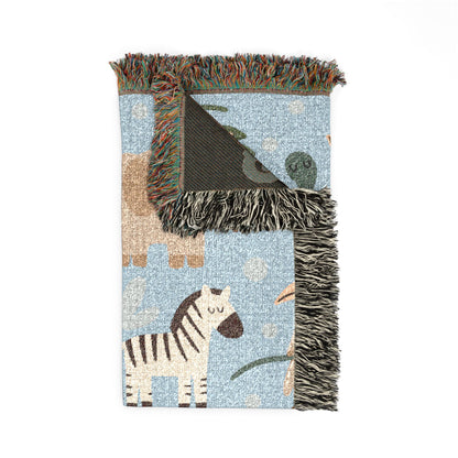 Folded safari animals woven baby blanket showing the fringed edge and the dark reverse side