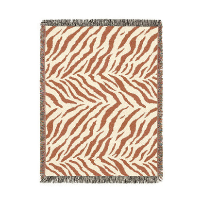 Safari woven blanket in cream with rust and terracotta zebra stripes, shown flat