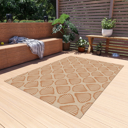 Sea Shell outdoor rug on a wooden deck beside a built-in bench and planters