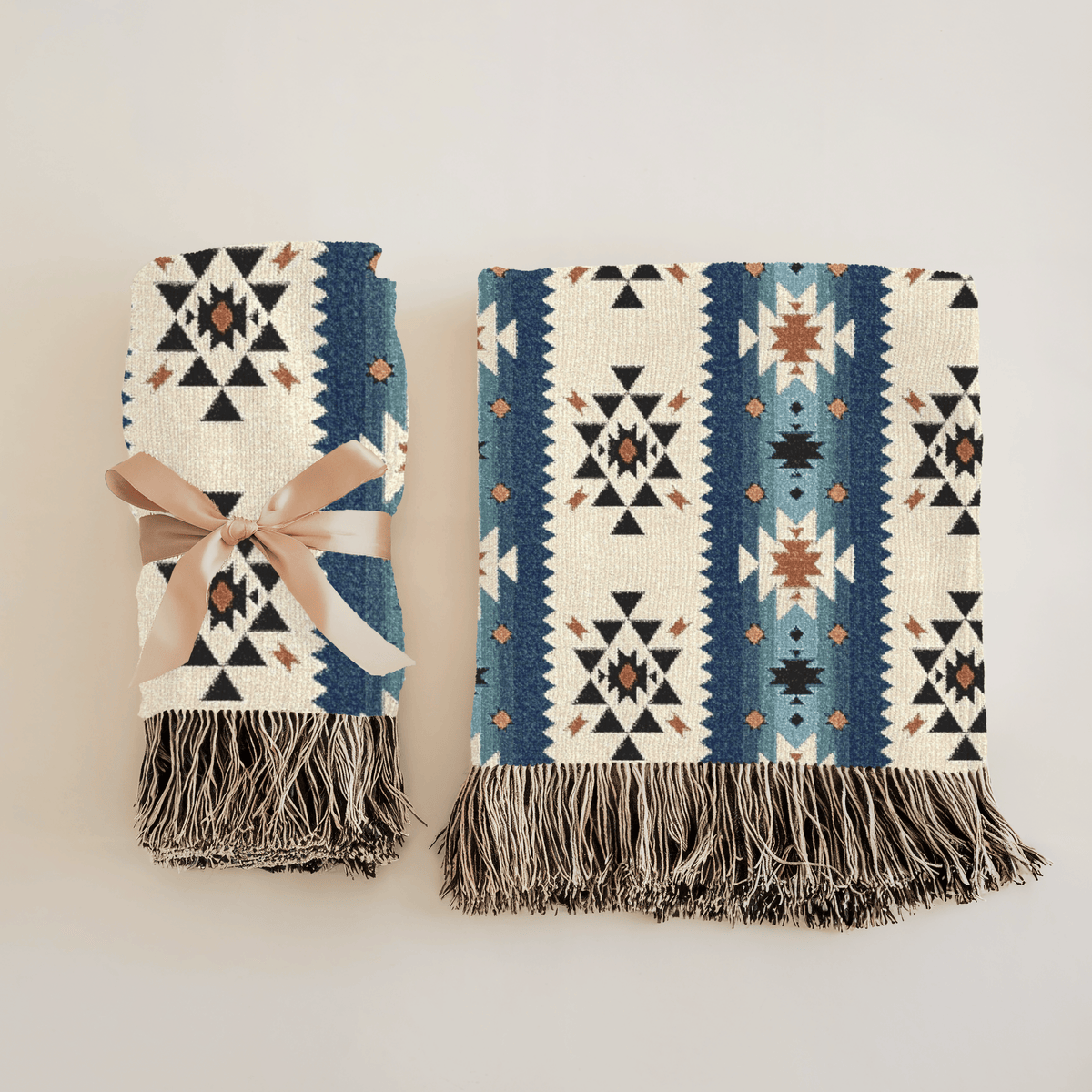 Two folded Southwestern woven blankets side by side, one tied with a ribbon, showing the front and the reverse side