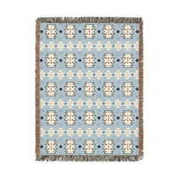Southwestern woven blanket in pale blue with cream and navy medallion motifs, shown flat