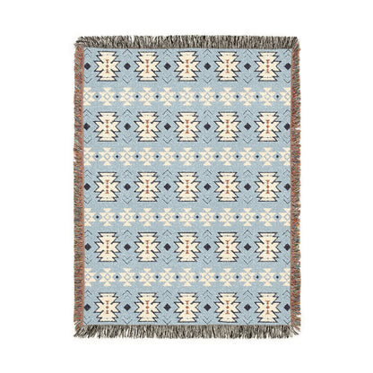 Southwestern woven blanket in pale blue with cream and navy medallion motifs, shown flat