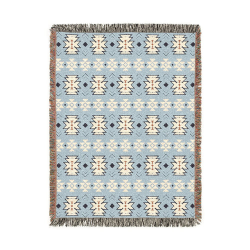Southwestern woven blanket in pale blue with cream and navy medallion motifs, shown flat