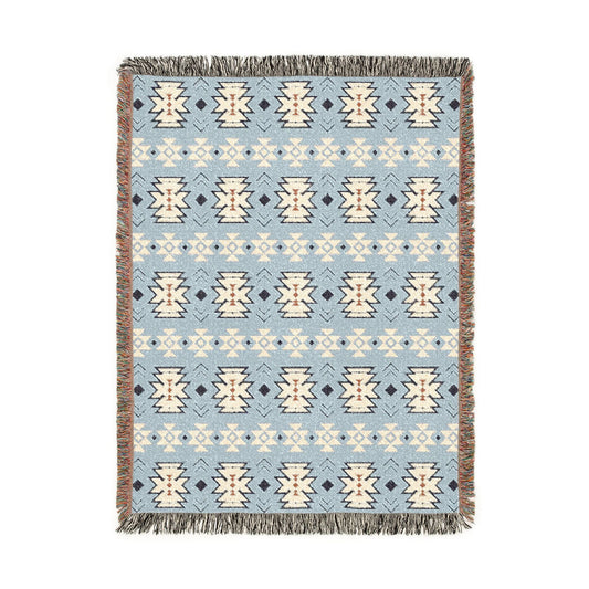 Southwestern woven blanket in pale blue with cream and navy medallion motifs, shown flat