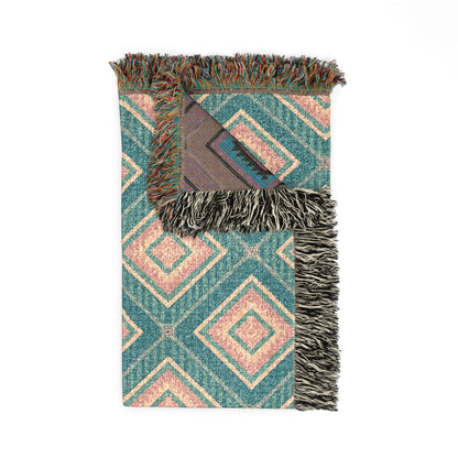Folded Southwestern teal and rose woven blanket showing the fringed edge and the reverse side