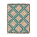 Southwestern woven blanket in teal with dusty rose and cream diamonds, shown flat