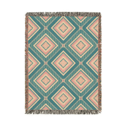 Southwestern woven blanket in teal with dusty rose and cream diamonds, shown flat