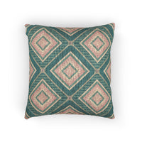 Southwestern woven pillow in teal, dusty rose and cream with concentric diamonds, front view