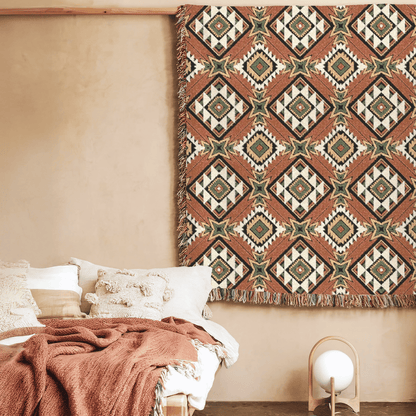 Star Medallion Aztec woven blanket styled on a bed in a cozy bedroom