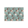 Summer Palm outdoor rug in seafoam green with coral palm trees, shown flat