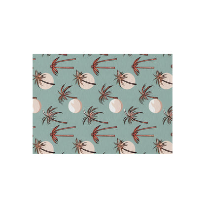 Summer Palm outdoor rug in seafoam green with coral palm trees, shown flat